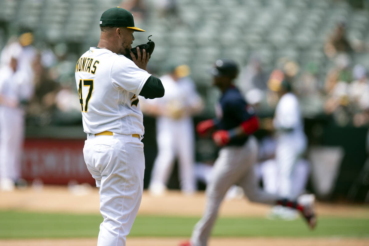 Oakland Athletics starting pitcher Frankie Montas (47) waits while Boston Red Sox's Franchy Cor ...