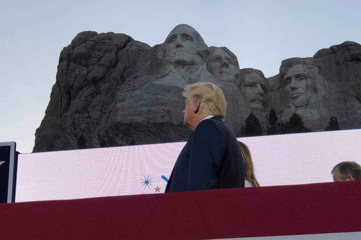President Donald Trump watches as planes perform fly-overs of the Mount Rushmore National Monum ...