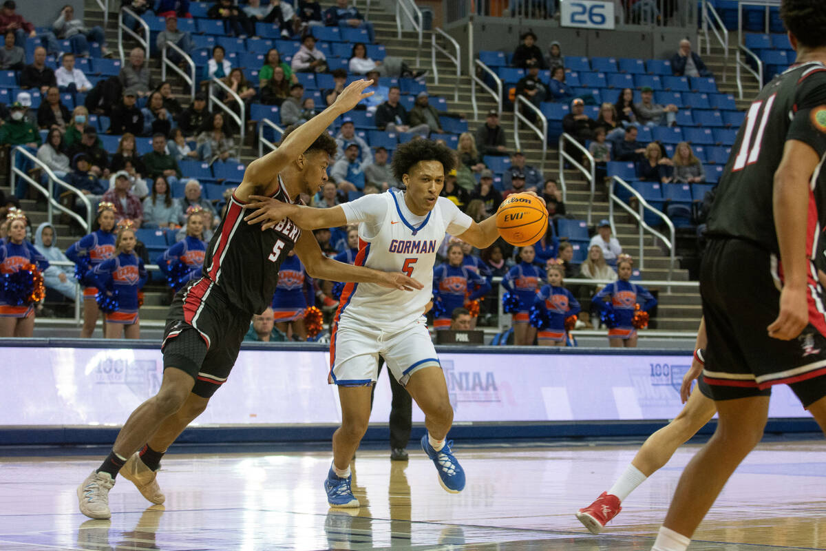 Bishop Gorman's Darrion Williams dribbles into Liberty defender Joshua Jefferson during the NIA ...