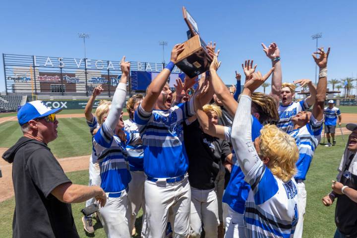 Basic players and coaches celebrate with the trophy after defeating Bishop Gorman 16-7 during t ...