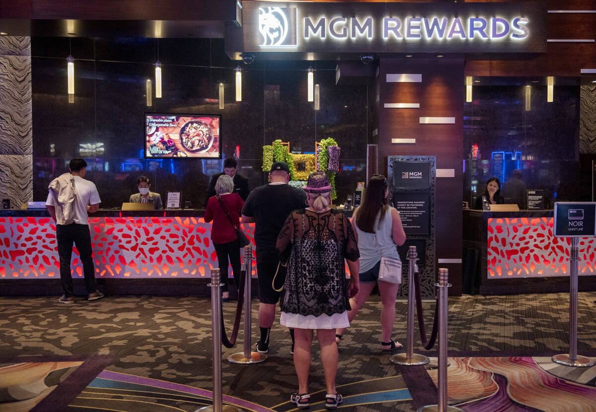 People wait in line at the MGM Rewards desk at the Aria hotel-casino on Friday, June 17, 2022, ...