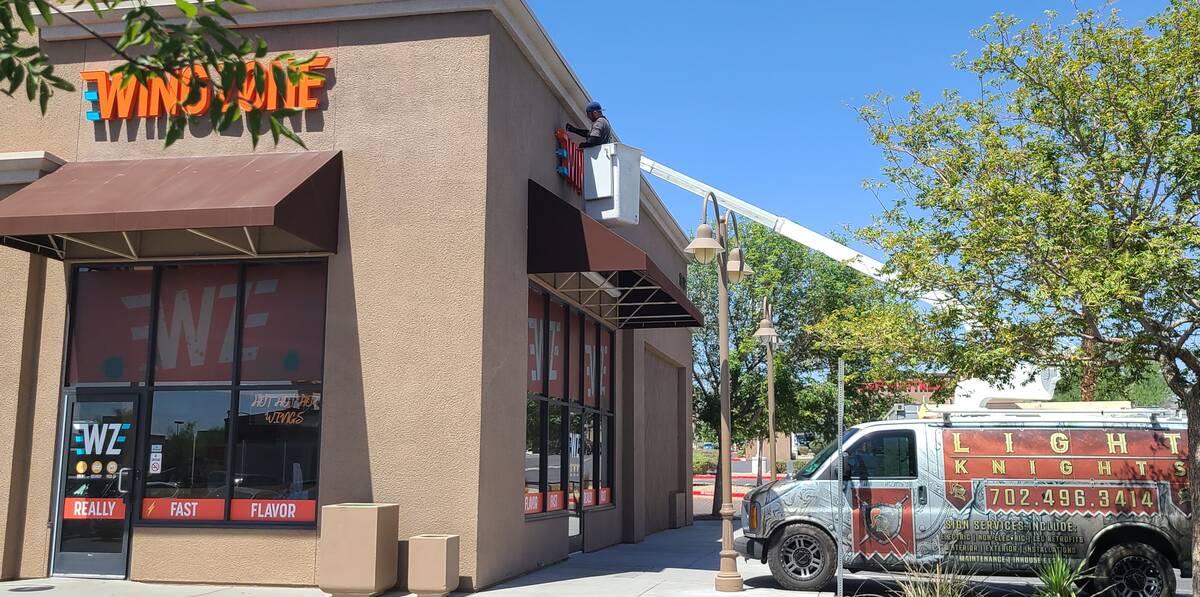 Gilbert Marino, the head sign installer for Light Knights Signs and Lighting, makes the final a ...