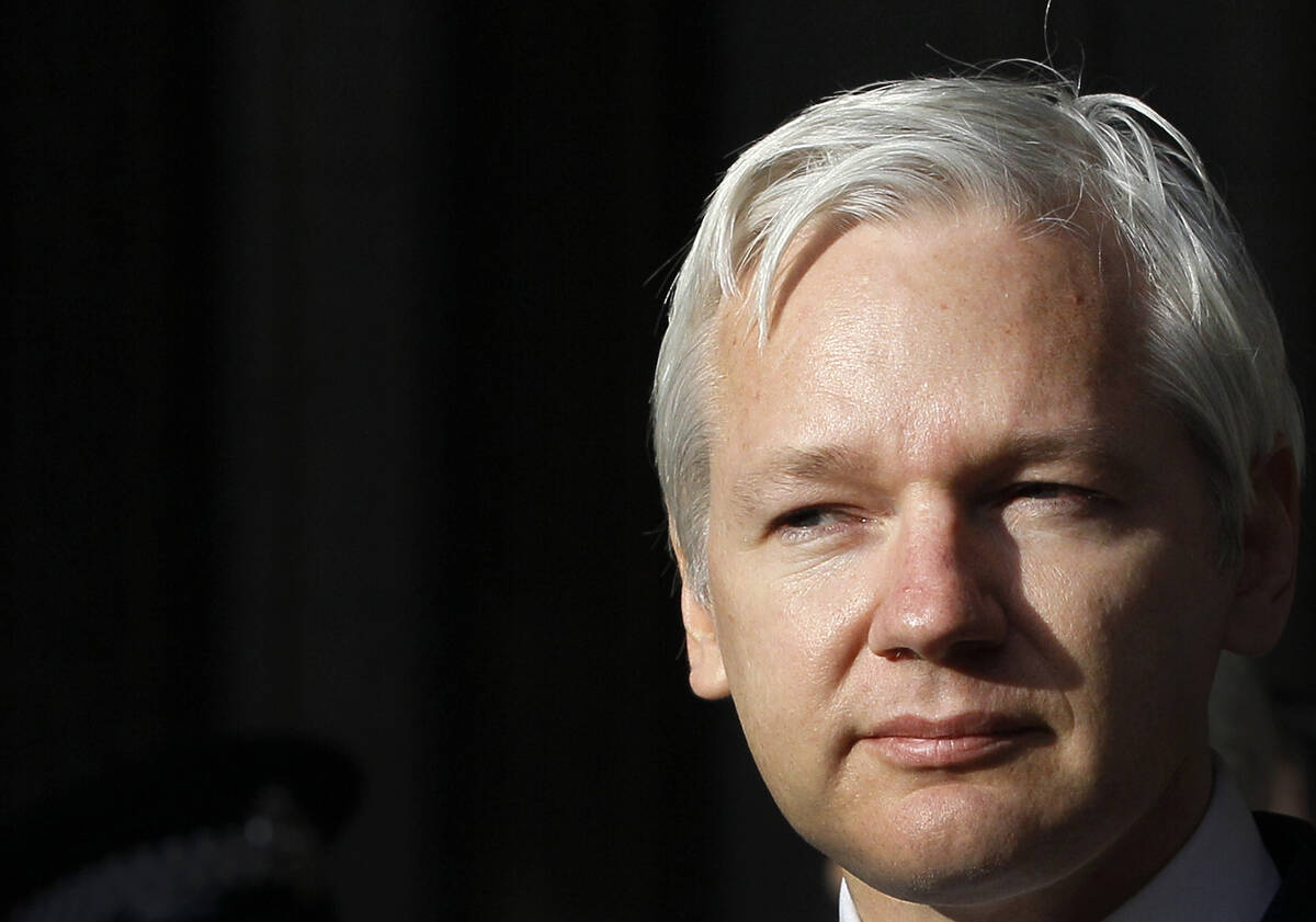 FILE - WikiLeaks founder Julian Assange pauses as he makes a statement to media gathered outsid ...