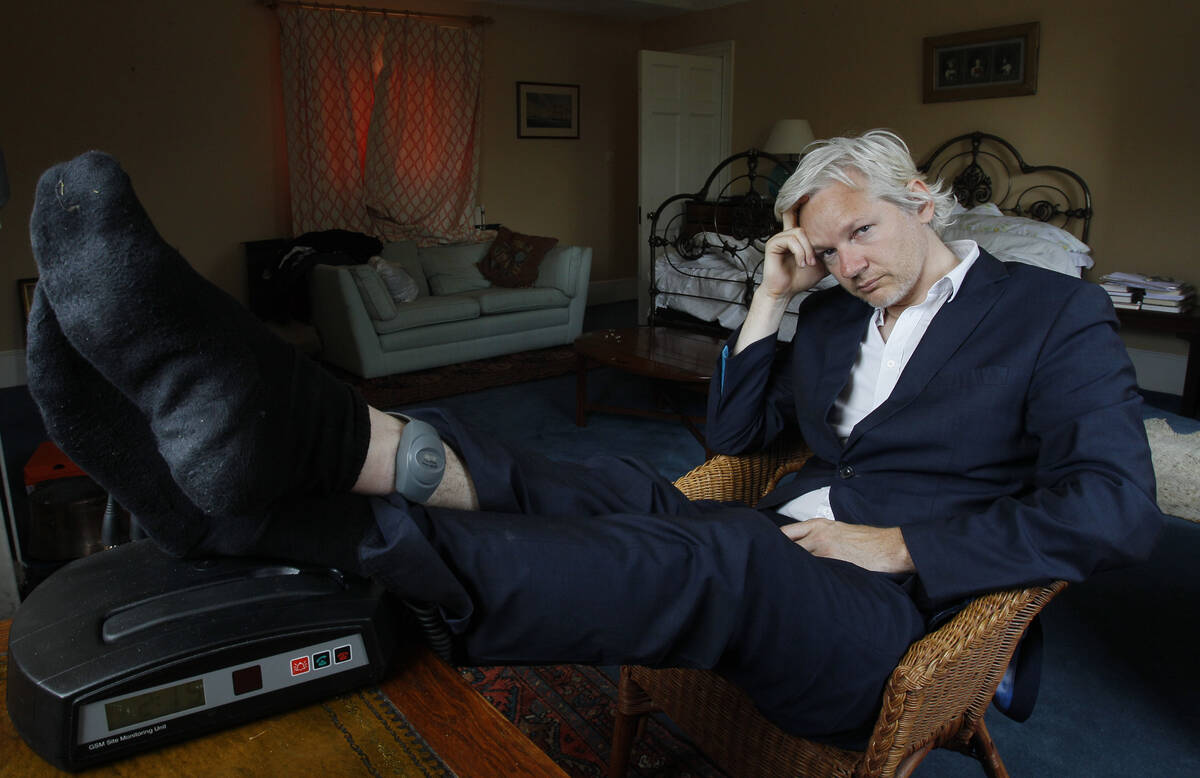 FILE - WikiLeaks founder Julian Assange is seen with his ankle security tag at the house where ...