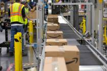 Boxes move down a conveyor belt during a tour of Amazon's North Las Vegas fulfillment center in ...