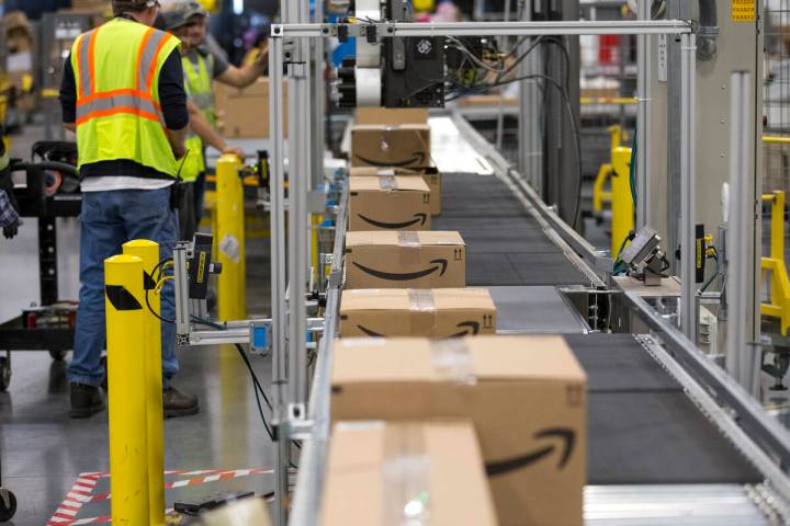 Boxes move down a conveyor belt during a tour of Amazon's North Las Vegas fulfillment center in ...