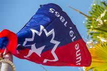 The Juneteenth Independence Day flag begins to flutter after its presentation during a flag pre ...
