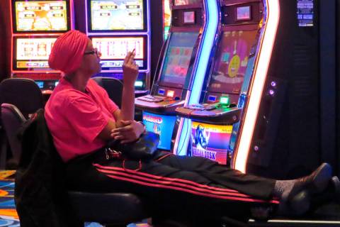 A gambler smokes while playing a slot machine at the Ocean Casino Resort on Feb. 10, 2022, in A ...
