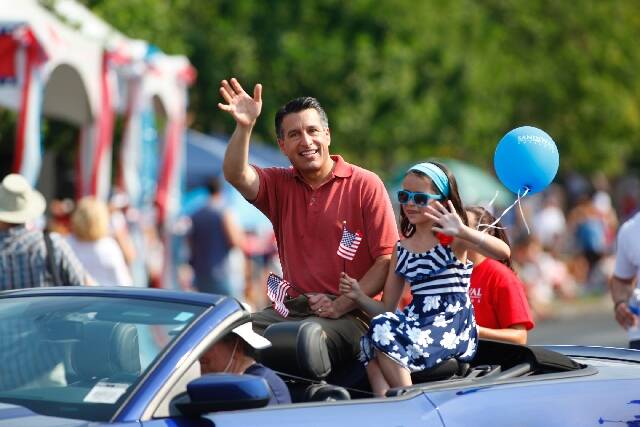 Nevada Gov. Brian Sandoval waves to the crowd during the 2013 Summerlin Council Patriotic Parad ...