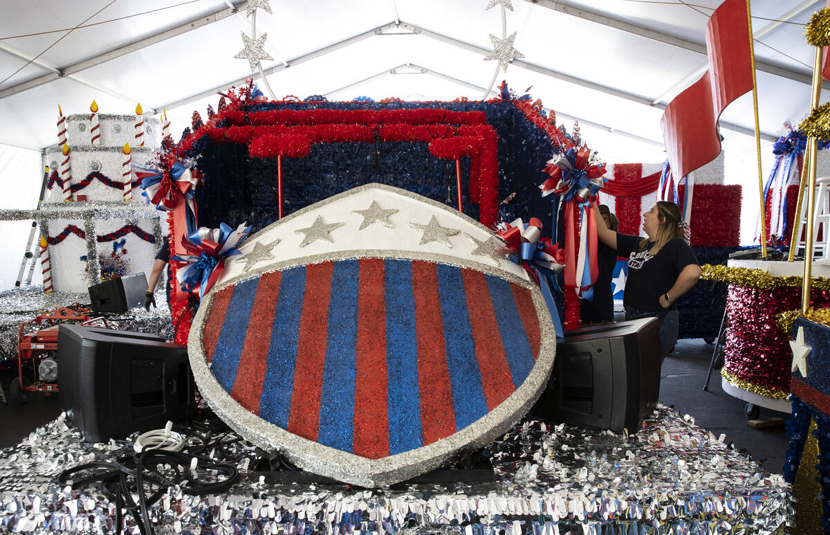 Jordyn Doyle, a volunteer, decorates the "Avengers" float for the Summerlin Council Patriotic P ...