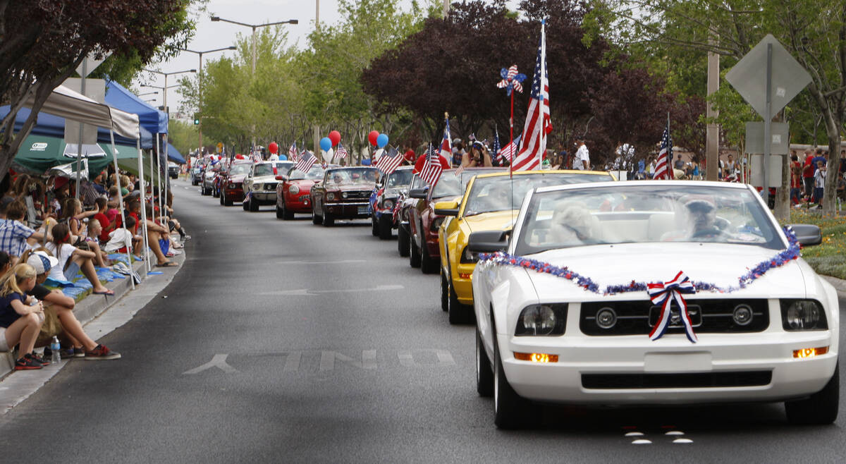 The crowd watches as members of the Las Vegas Mustang Club take part in the 2012 Summerlin Coun ...