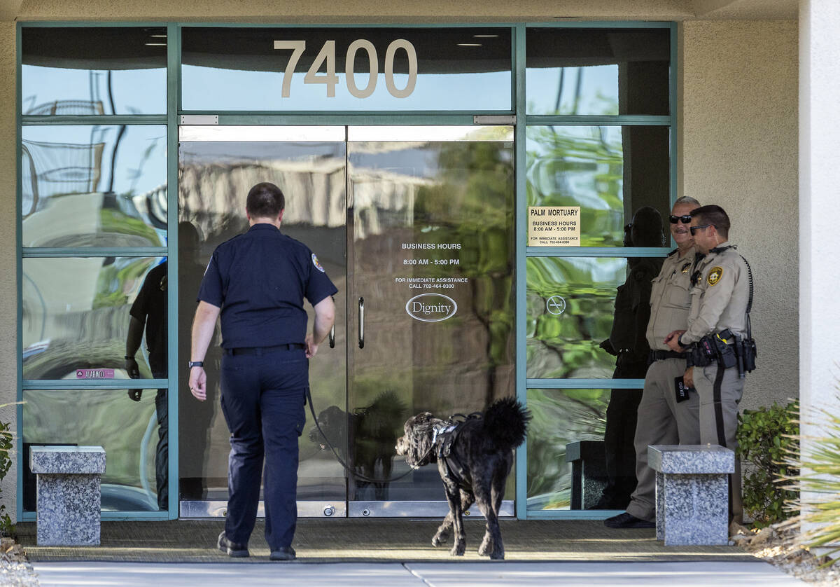 A dog handler walks in as officers stand by for a public viewing for Metro Det. Justin Terry at ...