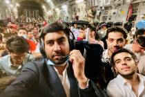 Mohammad "Benny" Shirzad translates for the crew and passengers aboard an evacuation flight out ...