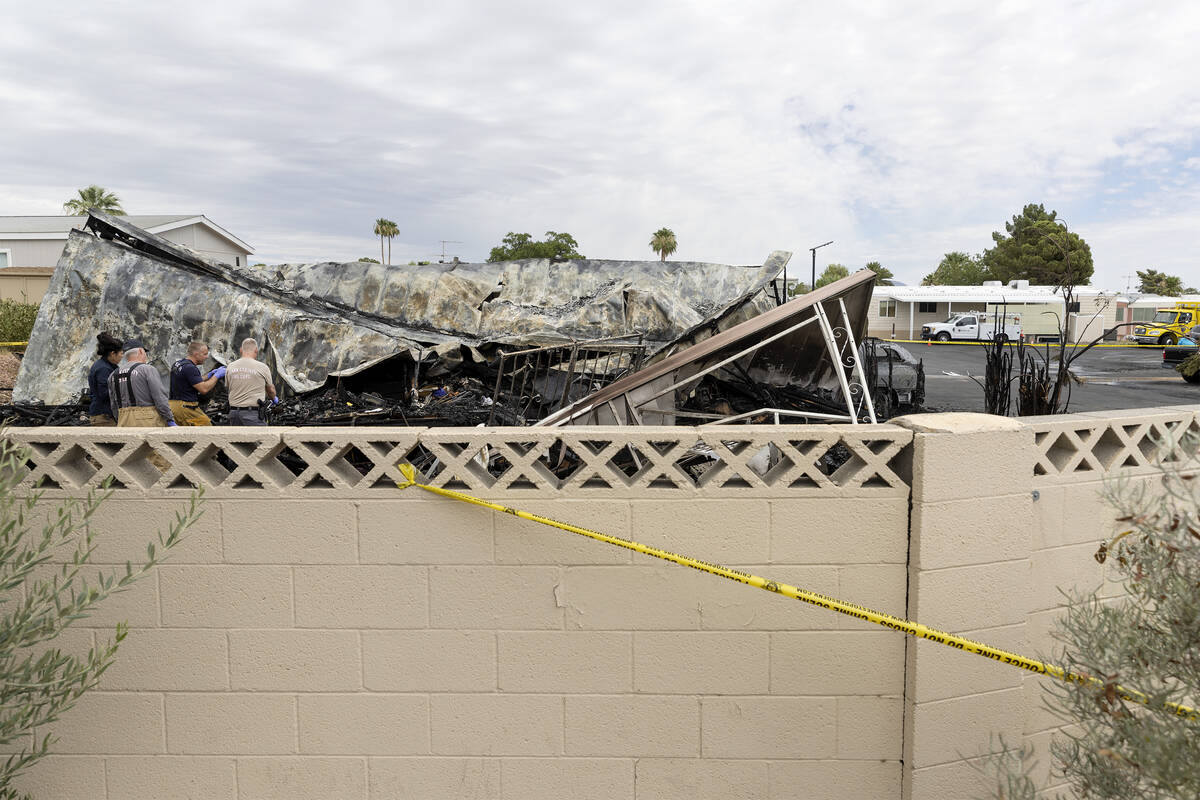 Clark County Fire Department and Las Vegas Fire and Rescue investigate the scene of a fire wher ...