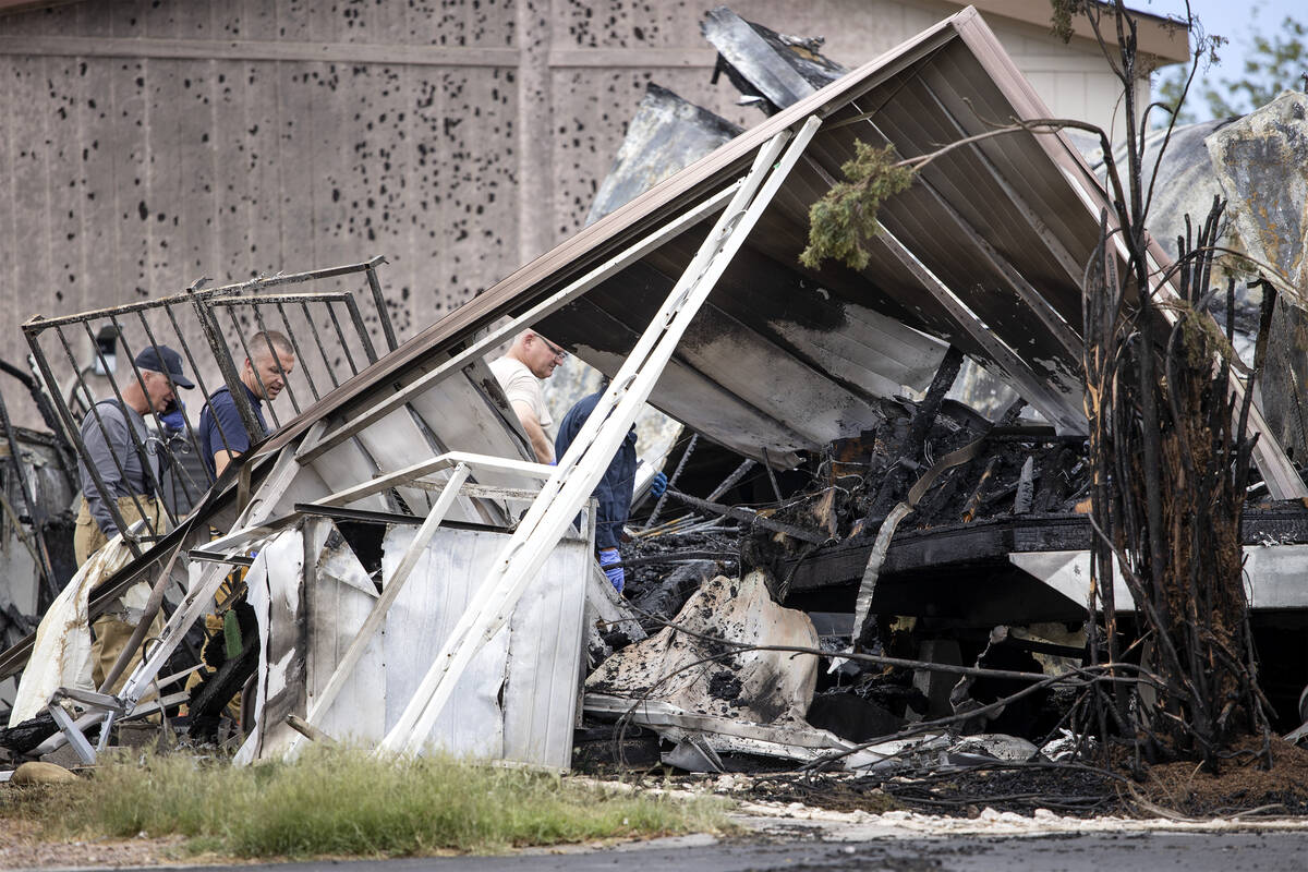 Clark County Fire Department and Las Vegas Fire and Rescue investigate the scene of a fire wher ...