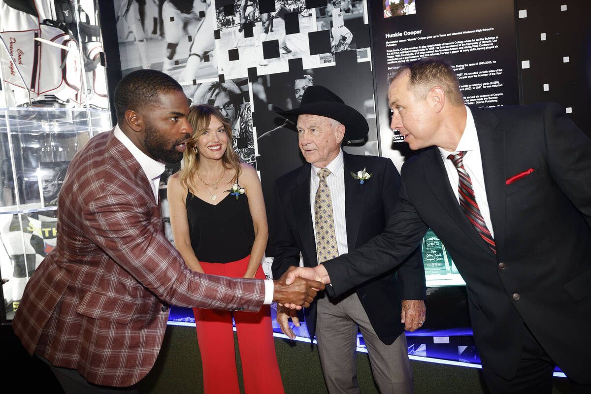 Southern Nevada Sports Hall of Fame inductee DeMarco Murray, left, shakes hands with Kelan Gond ...