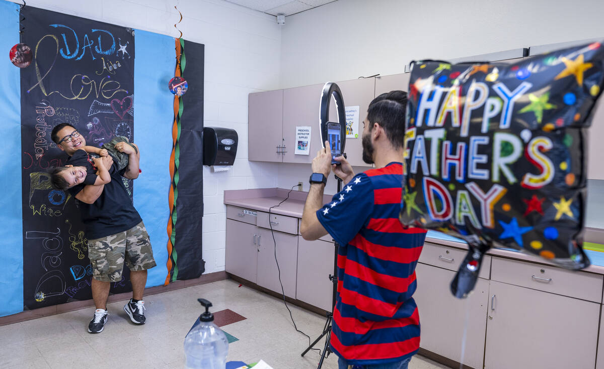 (From left) Peter Hyun has fun during a portrait with his son Leo, 2, taken by Ozzy Corona as t ...