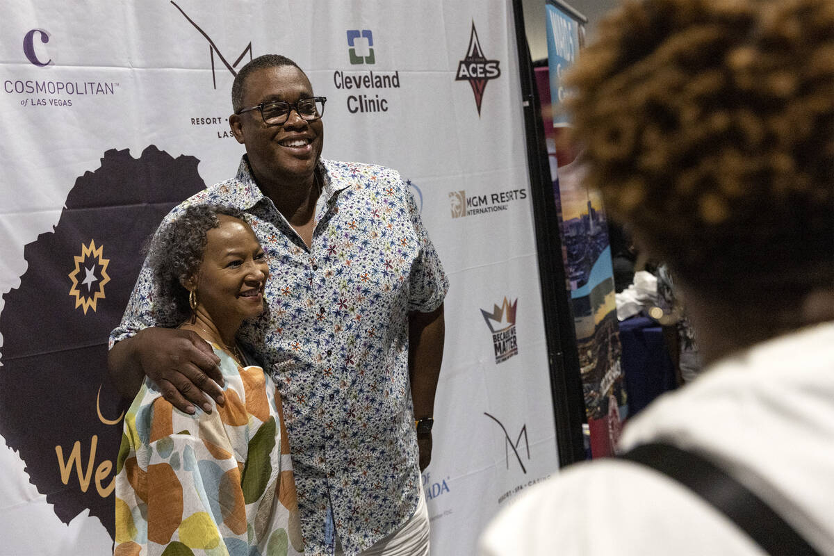 Las Vegas city councilman Cedric Crear, center left, poses for photos with an attendee of a Jun ...
