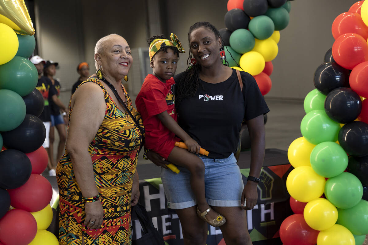 Lorelei Triche, left, Amara Agu, 4, and Amani Harlee pose for a photo during a Juneteenth expo ...