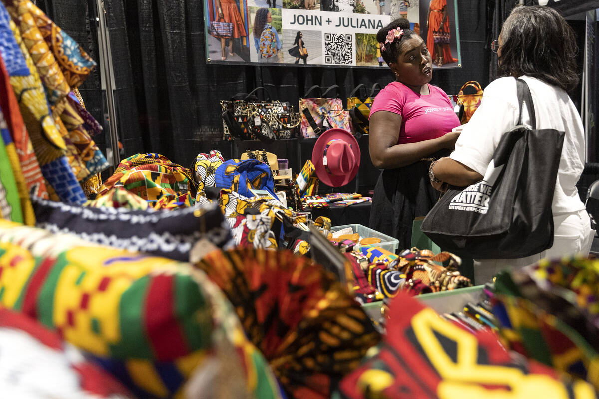 Eden Arunn, left, owner of John + Juliana, interacts with a customer during a Juneteenth expo a ...
