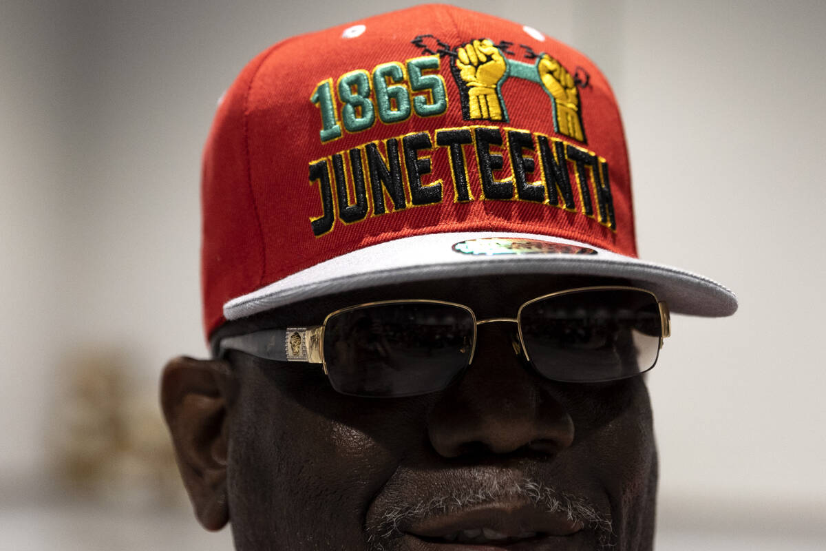 Raj Bey, of Philadelphia, who is considering moving to Las Vegas, wears a Juneteenth hat during ...