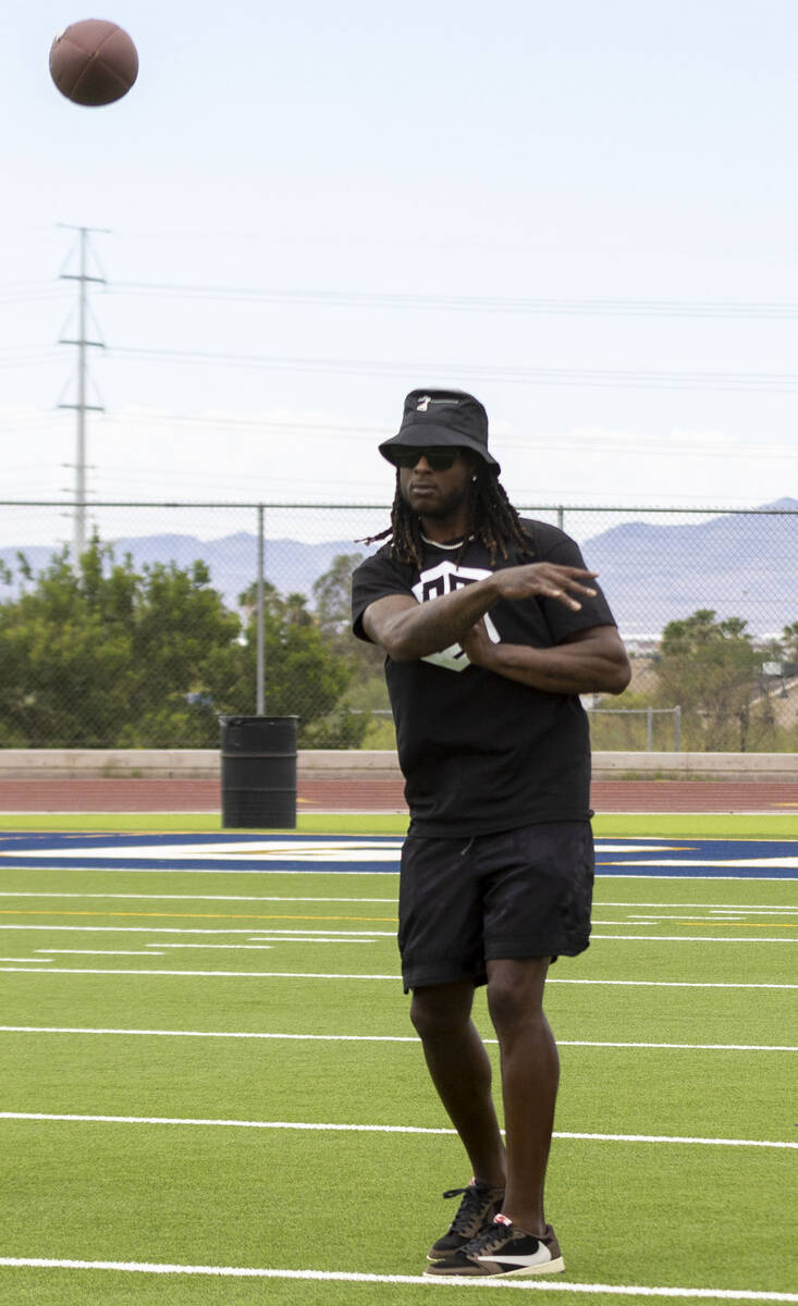 Raiders wide receiver Davante Adams throws a football at his youth football camp at Spring Vall ...