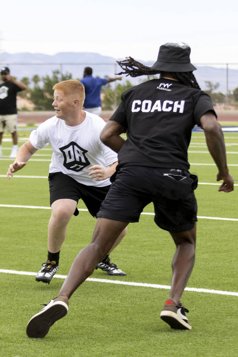 Raiders wide receiver Davante Adams runs a route against a young defender at his youth football ...