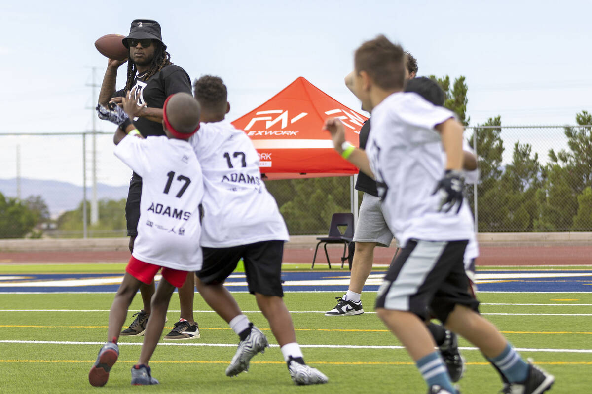 Raiders wide receiver Davante Adams throws the football at his youth football camp at Spring Va ...