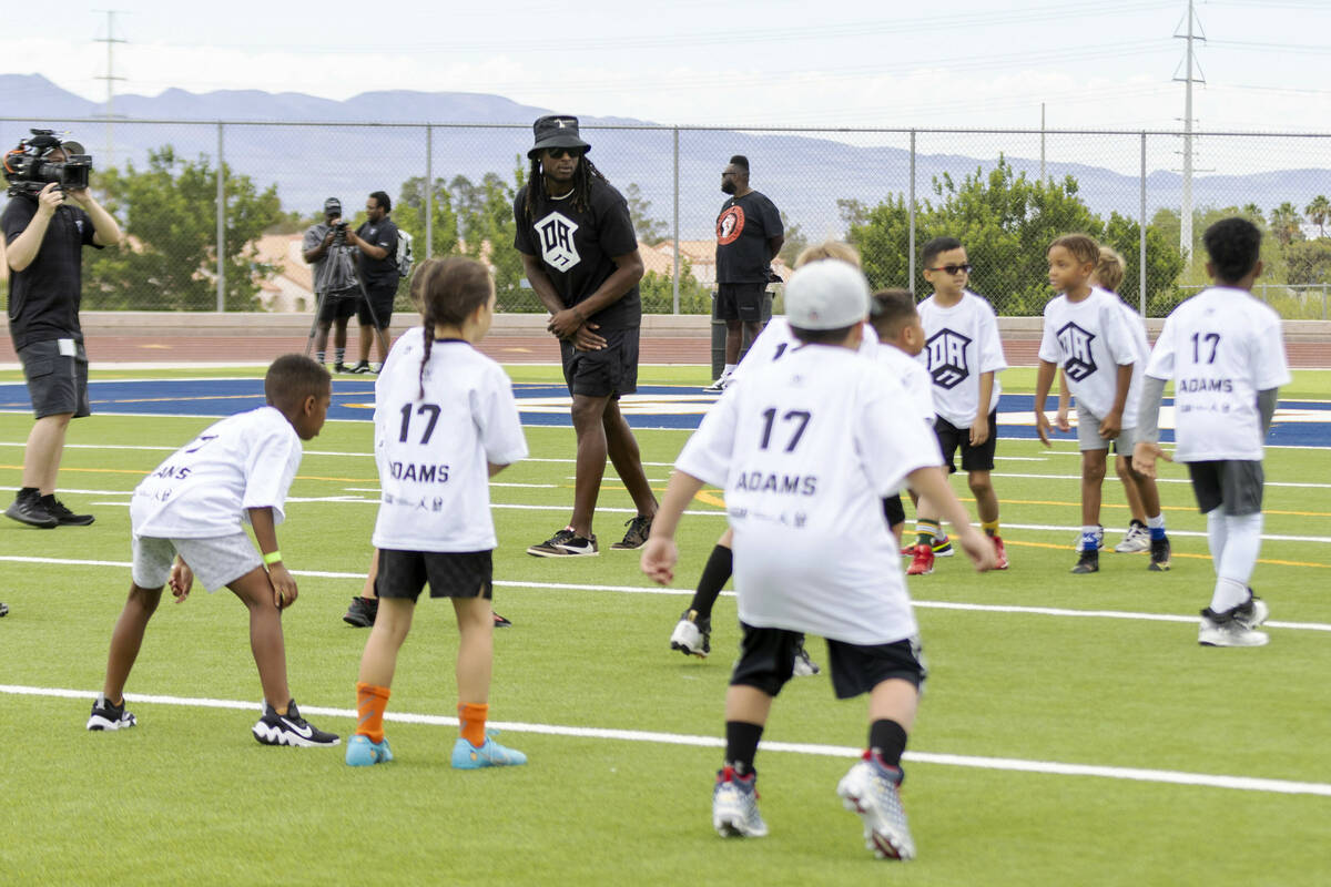 Raiders wide receiver Davante Adams lines up to run a route at his youth football camp at Sprin ...