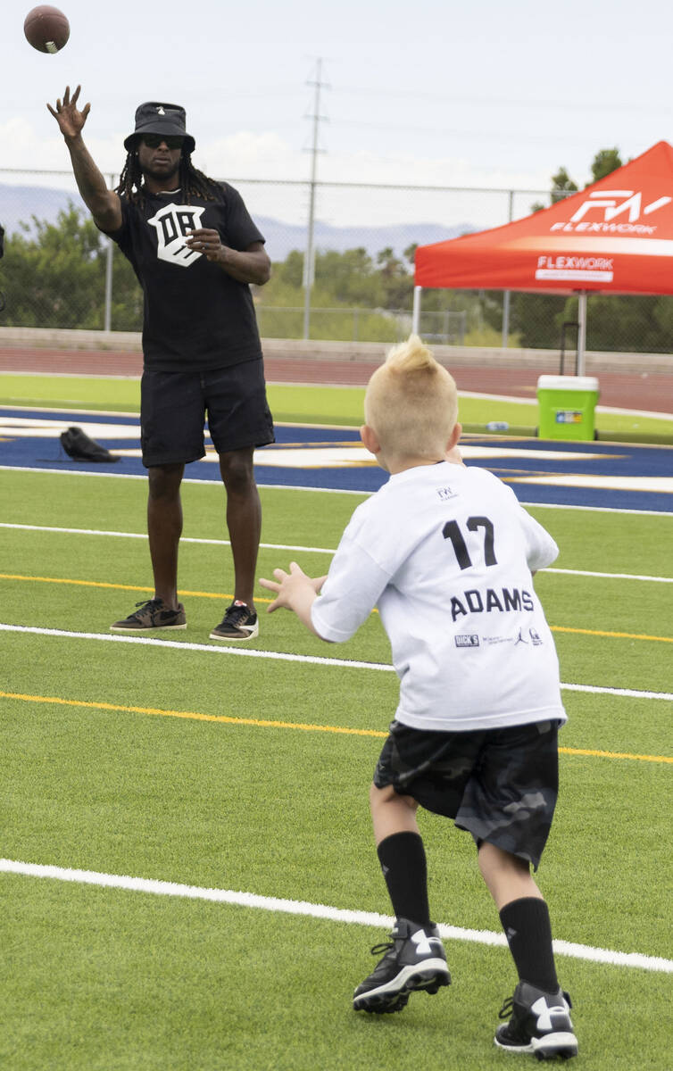 Raiders wide receiver Davante Adams throws a pass at his youth football camp at Spring Valley H ...