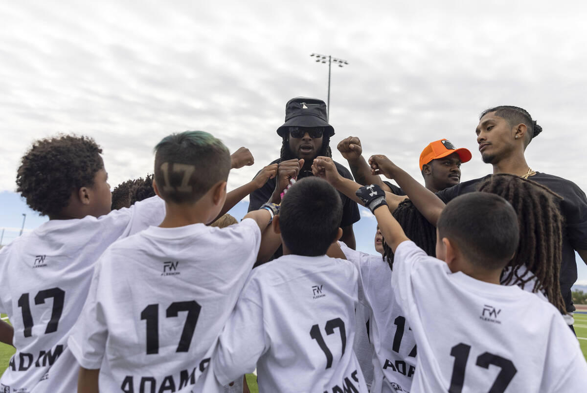 Raiders wide receiver Davante Adams coaches in the huddle at his youth football camp at Spring ...