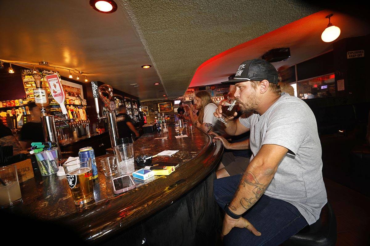 Adam Allen of Las Vegas drinks a glass of Joseph James Suave Felon #003 at Atomic Liquors, Satu ...