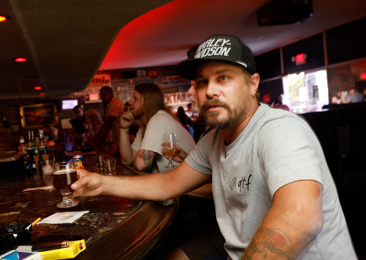 Adam Allen of Las Vegas holds a glass of Joseph James Suave Felon #003 at Atomic Liquors, Satu ...