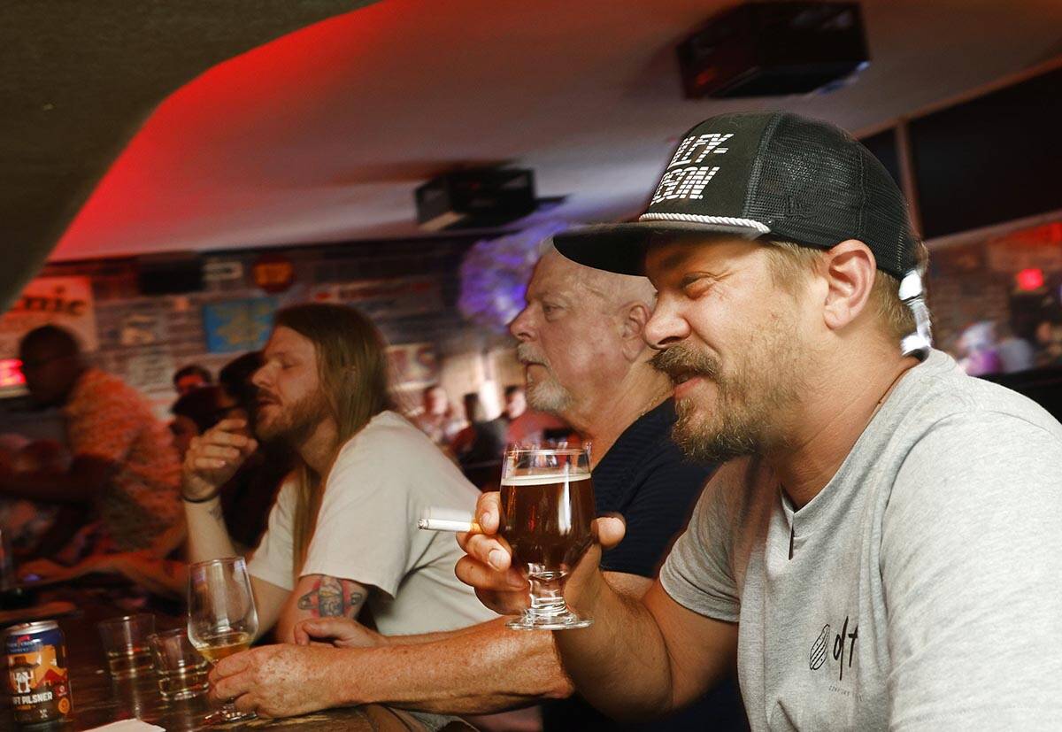 Adam Allen of Las Vegas holds a glass of Joseph James Suave Felon #003 at Atomic Liquors, Satu ...