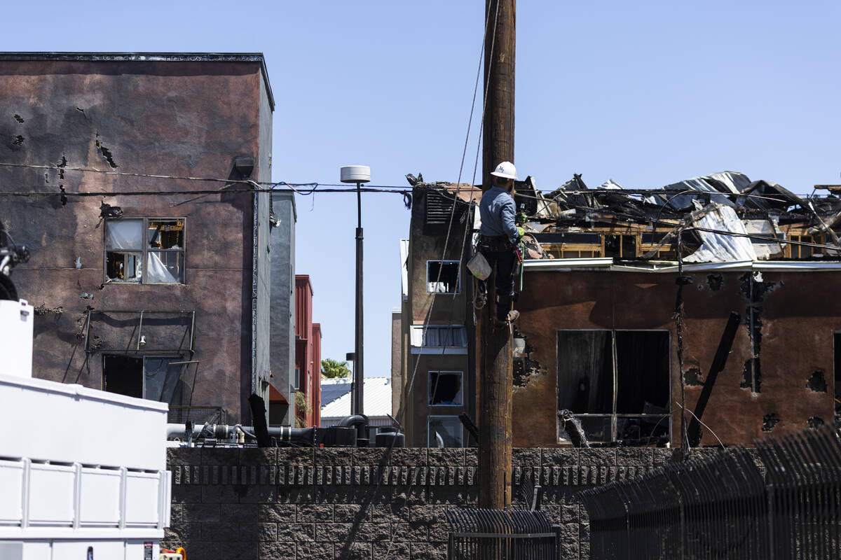 An NV Energy worker onsite at the scene where a fire damaged or destroyed at least 10 buildings ...