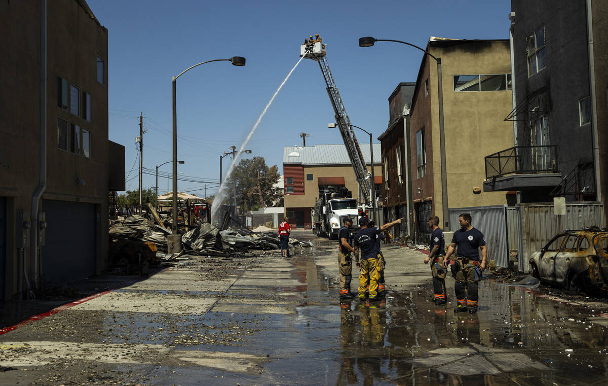 Las Vegas firefighters work the scene where a fire damaged or destroyed at least 10 buildings a ...
