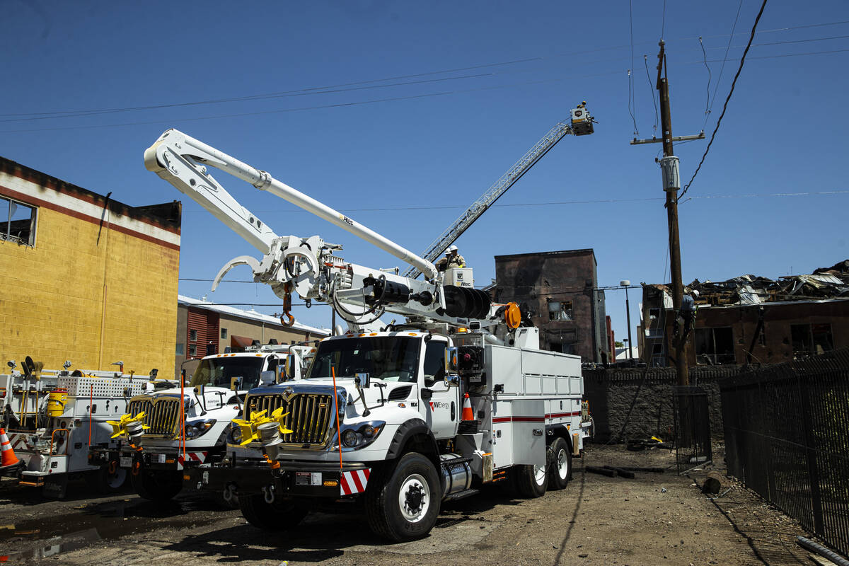 NV Energy crews work at the scene where a fire damaged or destroyed at least 10 buildings at a ...