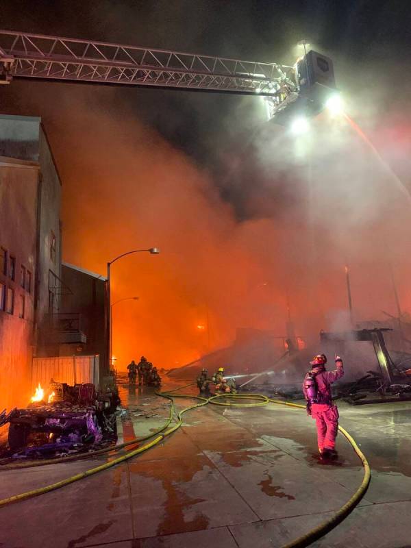 Firefighters try to extinguish a fire, Sunday, June 19, 2022, in downtown Las Vegas. (Las Vegas ...