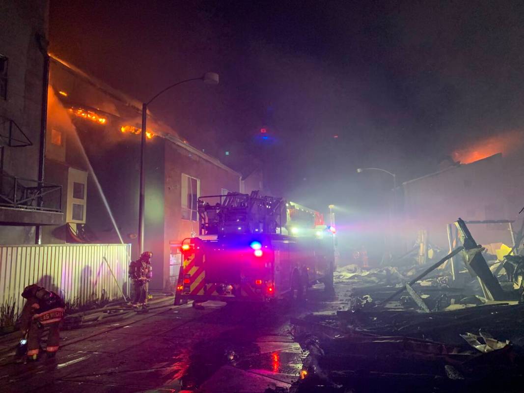 Firefighters try to extinguish a fire, Sunday, June 19, 2022, in downtown Las Vegas. (Las Vegas ...