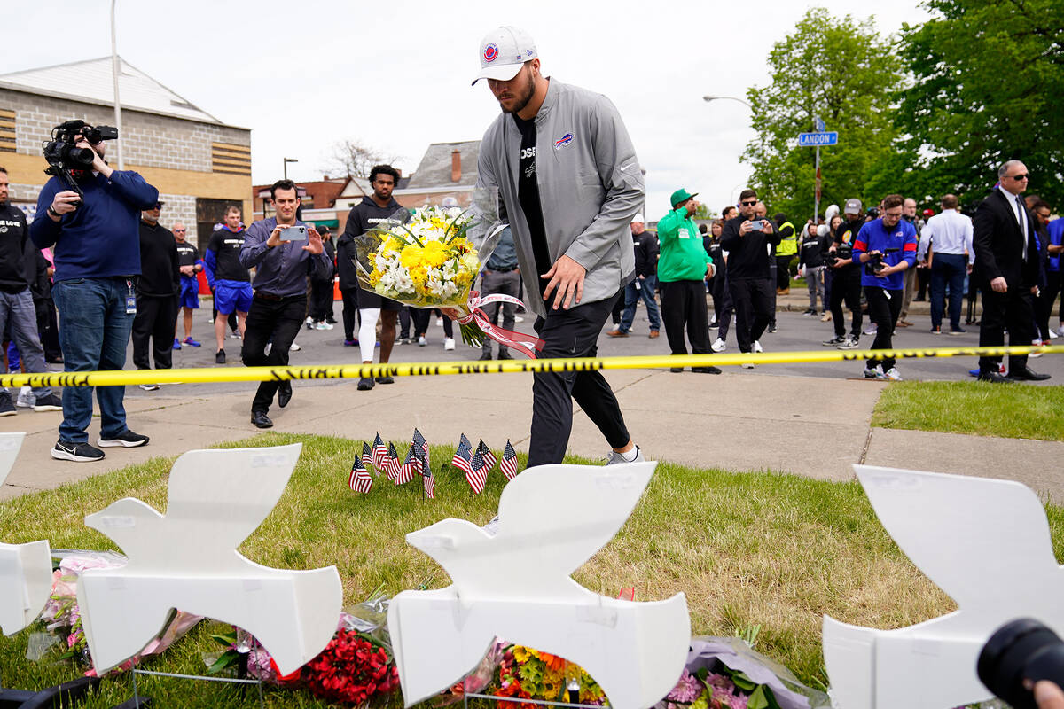 Buffalo Bills' Josh Allen visits the scene of Saturday's shooting at a supermarket, in Buffalo, ...