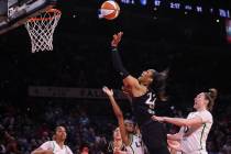 Las Vegas Aces forward A'ja Wilson (22) lays up the ball between Minnesota Lynx guard Moriah Je ...