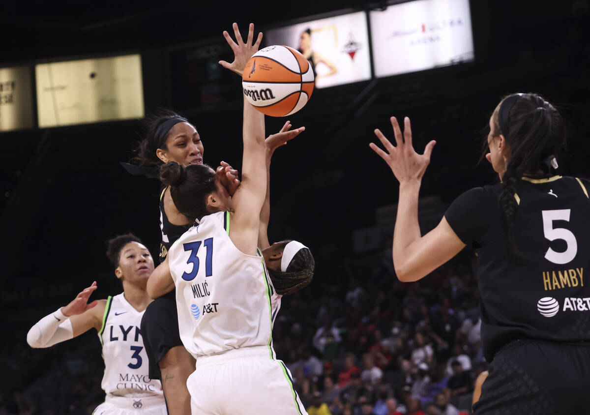 Las Vegas Aces forward A'ja Wilson (22) passes the ball over Minnesota Lynx center Nikolina Mil ...