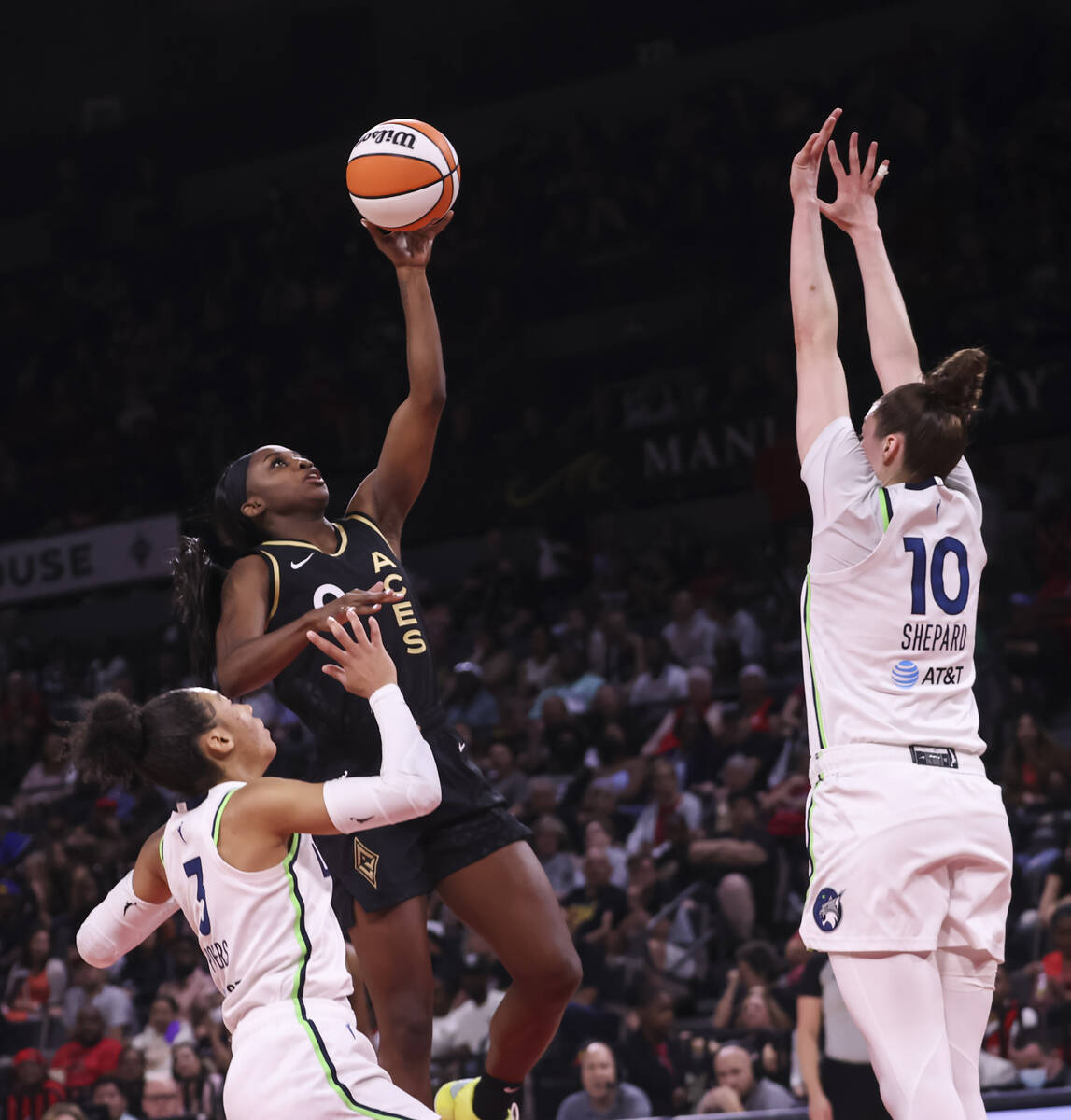 Las Vegas Aces guard Jackie Young (0) lays up the ball against Minnesota Lynx forwards Aerial P ...