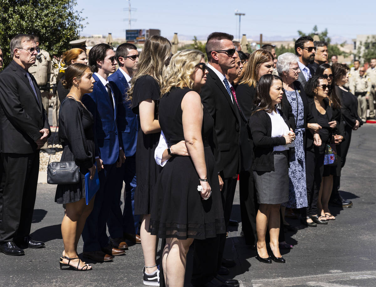 Family members watch as a Metropolitan Police Department honor guard unloads the casket of Las ...