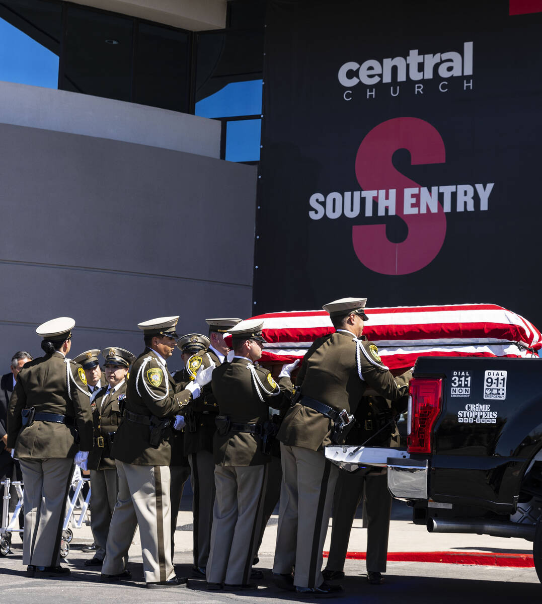 A Metropolitan Police Department honor guard unloads the casket of Las Vegas police Detective J ...