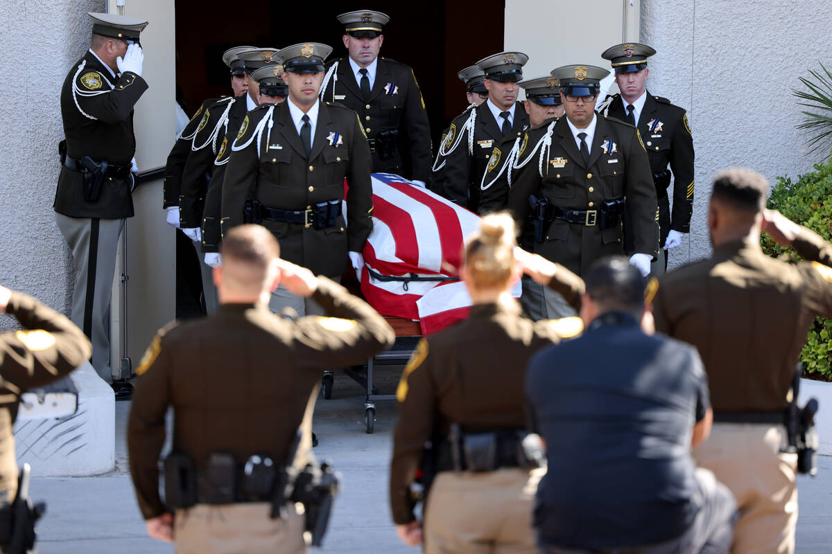 A Metropolitan Police Department honor guard loads the casket of Las Vegas police Detective Jus ...
