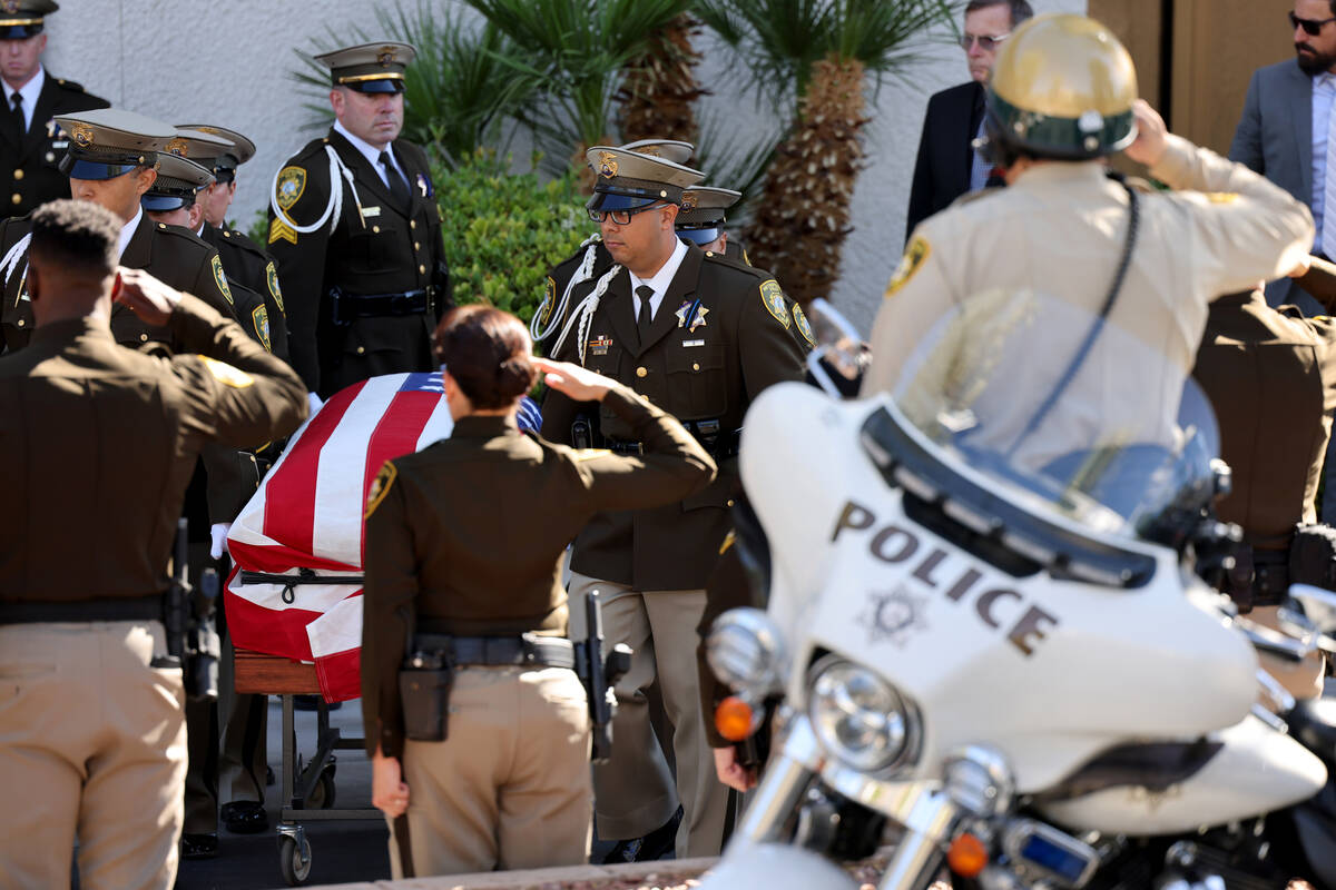 A Metropolitan Police Department honor guard loads the casket of Las Vegas police Detective Jus ...
