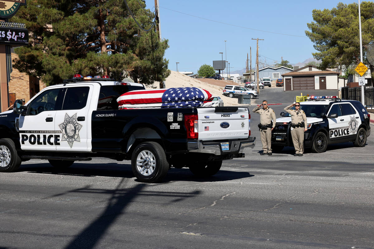 Metropolitan Police Department officers salute as the casket of Las Vegas police Detective Just ...
