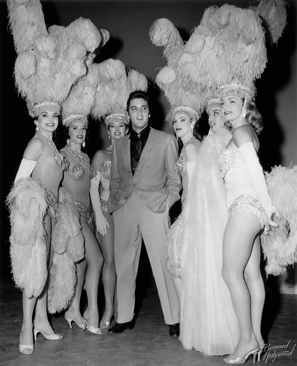 Elvis Presley poses with Las Vegas showgirls in a photo from the book "Vegas Gold" by David Wil ...
