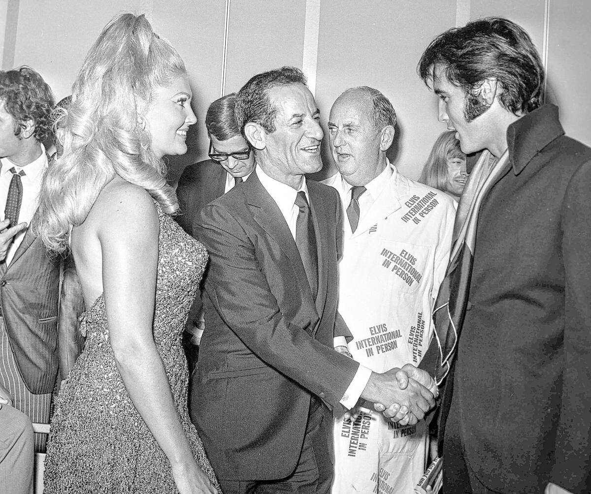 Joan and Alex Shoofey, left, talk with Elvis Presley at the International Hotel during a press ...